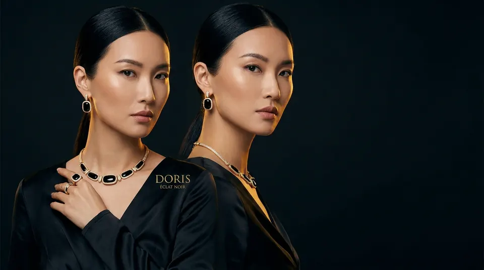 Two models in black wearing onyx jewelry